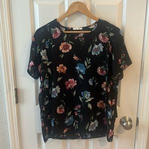 Women’s black floral short-sleeve blouse in size medium